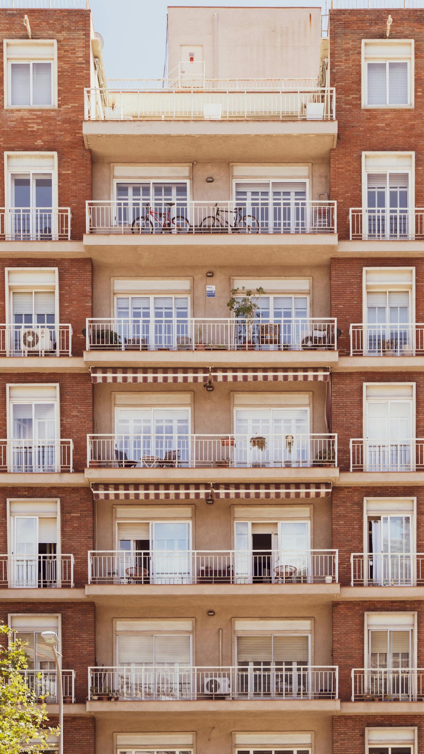 Front view of a multi-story apartment building facade in Barcelona.
